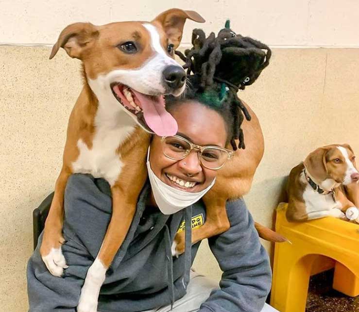 Woman with a dog on her shoulders