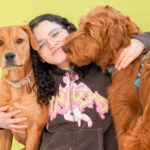 Staff hugging happy dogs